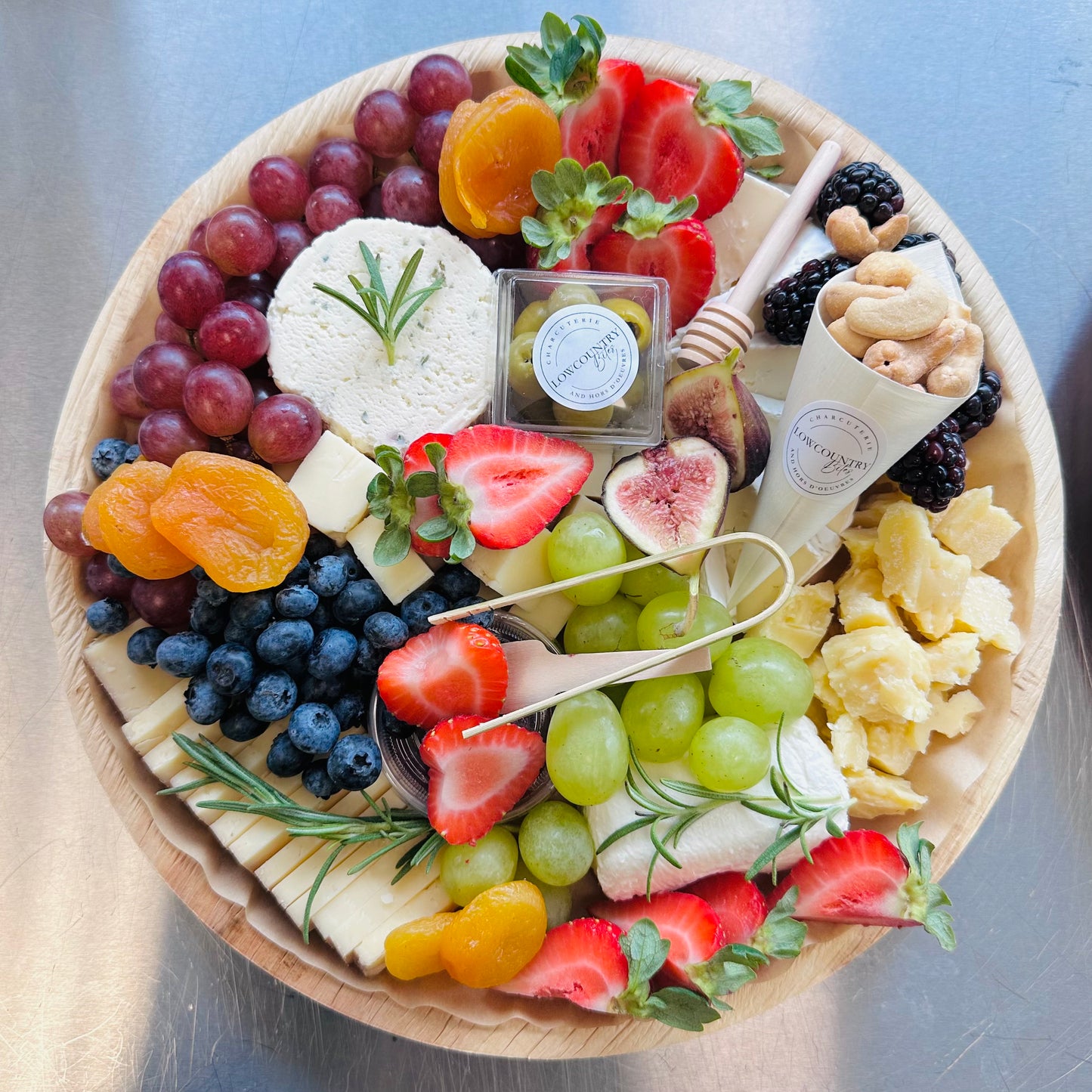 A charcuterie board featuring an assortment of cheeses, fruits, and nuts, arranged elegantly on a platter.