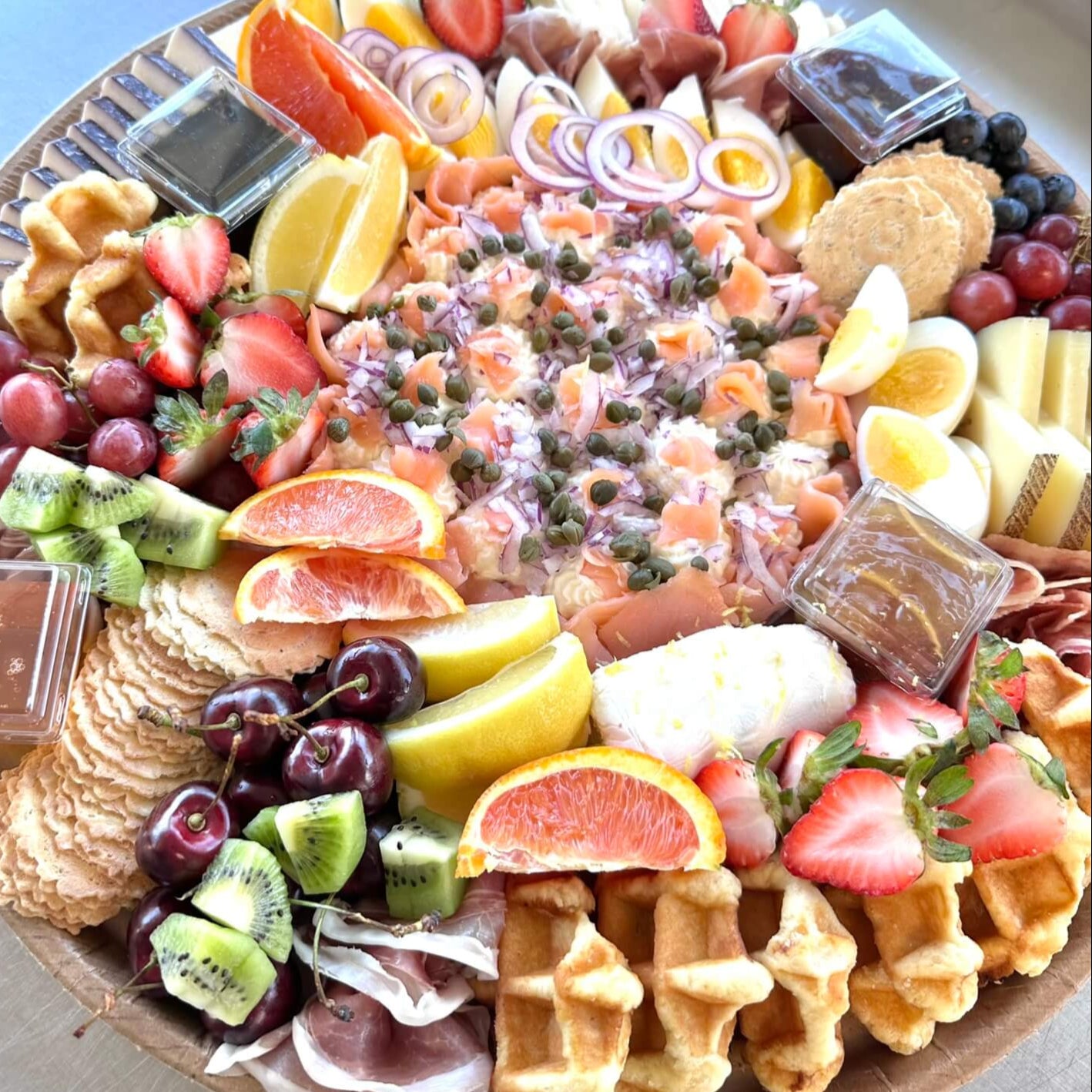 Delicious brunch boards with bagels, smoked salmon, fruit & more. Serves 8–16. Available in Murrells Inlet & surrounding areas.