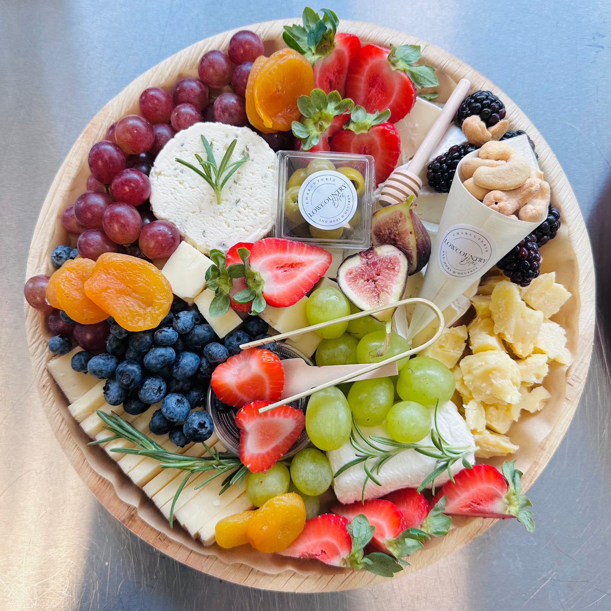 A cheese board featuring an assortment of cheeses, fruits, and nuts, arranged elegantly on a platter.